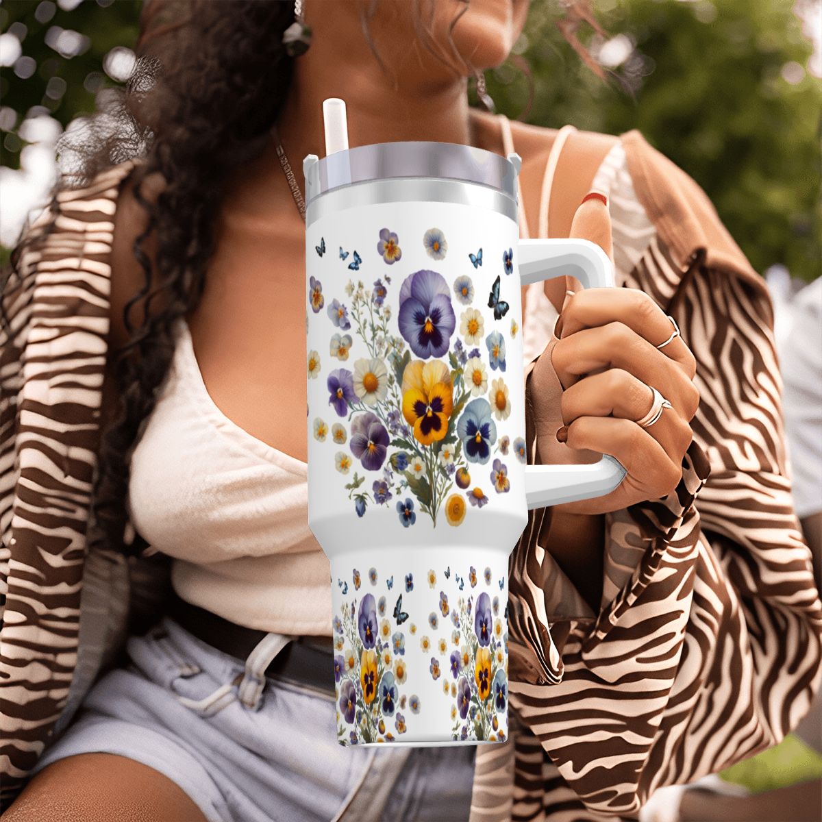 40oz stainless steel tumbler featuring real-look pressed pansies, a convenient handle, and a reusable straw.