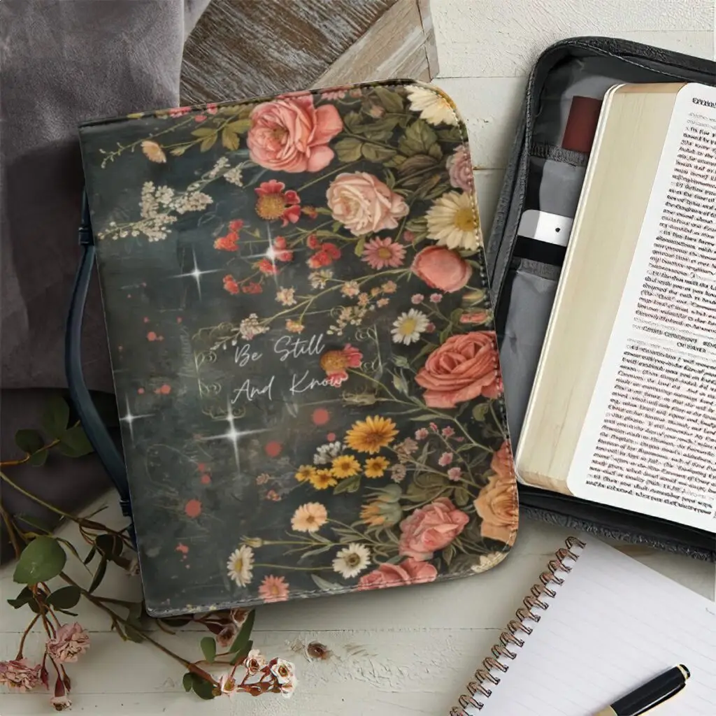 Wrap your Bible in peace and beauty with this vintage-inspired floral Bible cover, featuring the calming scripture “Be Still and Know.” Surrounded by soft roses, daisies, stars, this zippered cover is perfect for your quiet time, church study group, or gifting someone special.